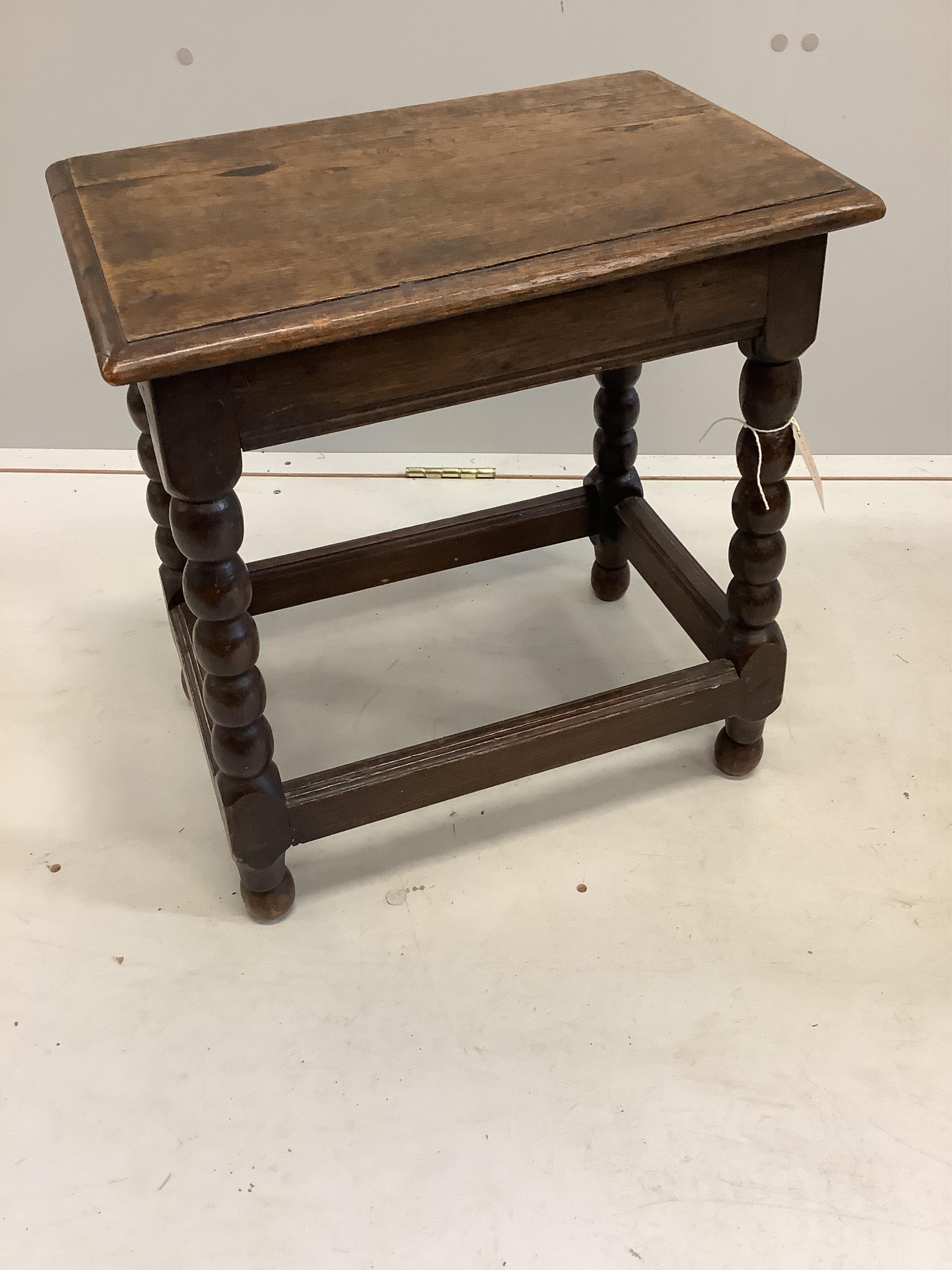 A 17th century style turned oak stool, width 46cm, depth 29cm, height 50cm